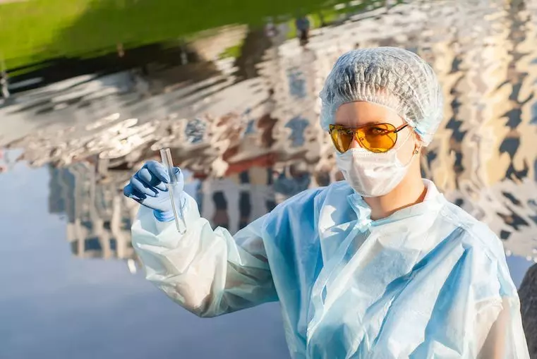Researcher in laboratory representing environmental standards