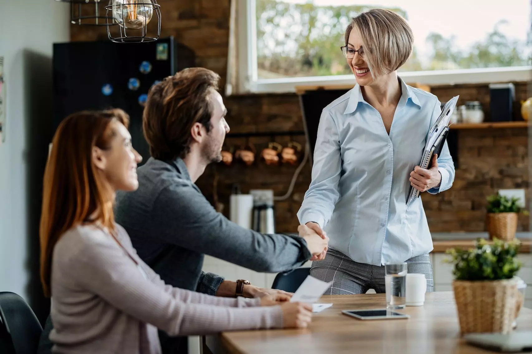 Employees speaking together in a collaborative workplace setting